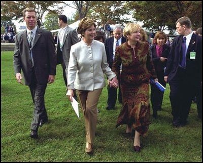 Laura Bush and Ludmila Putina, wife of Russian Federation President Vladimir Putin, stroll across the lawn of the Capitol visiting the tents of authors and story tellers at the Second Annual National Book Festival Saturday, October 12, 2002.