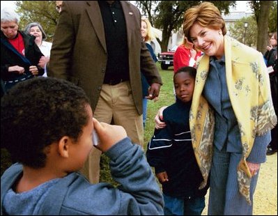 Mrs. Bush poses with children during her visit to the 2003 National Book Festival on the National Mall in Washington, D.C., Oct. 4, 2003.