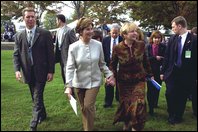 Laura Bush and Ludmila Putina, wife of Russian Federation President Vladimir Putin, stroll across the lawn of the Capitol visiting the tents of authors and story tellers at the Second Annual National Book Festival Saturday, October 12, 2002. White House photo by Susan Sterner.