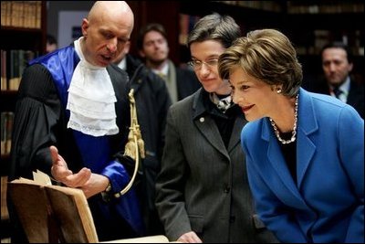 Laura Bush looks at an Ancient Thesis of Montichelli during a tour given by Paolo Novaria, Archives, left, at the University of Turin Saturday, Feb. 11, 2006, in Turin, Italy.