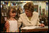 Five-year-old Reese stands with Mrs. Laura Bush at the Westbank Community Library in Austin during the announcement Tuesday, Aug. 14, 2007, of the Laura Bush Community Library. The library is the first public library in the United States to be named for Mrs. Bush, a former teacher and librarian.