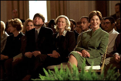 Hosting the Mark Twain Symposium, Laura Bush sits with Patricia Rowland and documentary filmmaker Ken Burns, in the East Room Nov. 29, 2001.