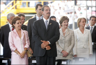 Laura Bush stands next to President Vicente Fox and his wife Marta Sahagun de Fox of Mexico during the inaugural ceremony of President Oscar Arias at the Estadio Nacional in San Jose, Costa Rica, Monday, May 8, 2006.