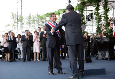 President Oscar Arias is embraced by outgoing President Abel Pacheco during the inaugural at the Estadio Nacional in San Jose, Costa Rica, Monday, May 8, 2006.