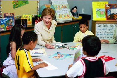 Laura Bush laughs with First Grade reading students at the George F. Kelly School in Boston July 9, 2004.