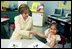 Laura Bush meets a First Grade reading student at the George F. Kelly School in Boston July 9, 2004.