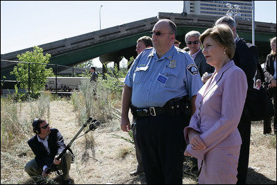 Mrs. Laura Bush surveys the wreckage of the I-35W bridge collapse with Deputy Chief of Police Robert "Rob" Allen in Minneapolis, Friday,Aug. 3, 2007. Mrs. Bush also visited an Emergency Operation Command Center and met with volunteers and first responders.