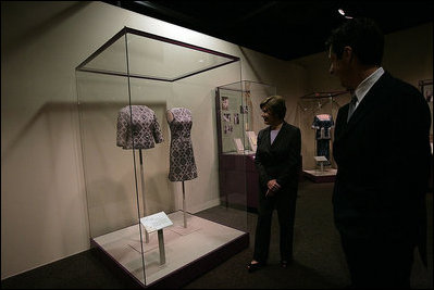 Mrs. Laura Bush looks at a dress worn by Jacqueline Kennedy during a tour of the exhibit First Ladies: Political Role and Public Image at the National Constitution Center Monday, Oct. 1, 2007, in Philadelphia.