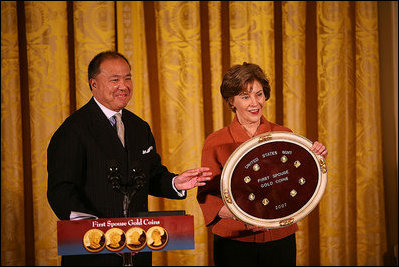 Mrs. Laura Bush and U.S. Mint Director Ed Moy hold up the Dolley Madison Gold Coin Monday, Nov. 19, 2007, in the East Room. "Today, we're paying tribute to an amazing First Lady, and an extraordinary woman, with the Dolley Madison Gold Coin," said Mrs. Bush. "Over the last year, since the U.S. Mint launched the First Ladies series, these coins have been extremely popular: The likenesses of Martha Washington, Abigail Adams, and Jefferson's Lady Liberty sold out within hours of their release. Their appeal reflects the enthusiasm of America's coin collectors, the public's fascination with American history, and Americans' interest in our remarkable First Ladies."