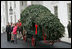 Mrs. Laura Bush welcomes the arrival of the official White House Christmas tree Monday, Nov. 26, 2007, to the North Portico of the White House. The 18-foot Fraser Fir tree, from the Mistletoe Meadows tree farm in Laurel Springs, N.C., will be on display in the Blue Room of the White House for the 2007 Christmas season. Joining Mrs. Bush, from left are, Beth Walterscheidt, president of the National Christmas Tree Association, and Joe Freeman and his wife Linda Jones of Mistletoe Meadow tree farm in Laurel Springs, N.C.