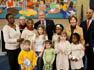President George W. Bush and Laura Bush are joined by Washington, D.C. Mayor Adrian Fenty, right, and Ginnie Cooper,Chief Librarian for the Washington, D.C. libraries, left, posing for photos with children and staff at a reading class commemorating Martin Luther King Day Monday, Jan. 21, 2008, at the Martin Luther King Jr. Memorial Library.