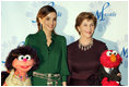 Mrs. Laura Bush stands with Her Majesty Queen Rania Al-Abdullah of Jordan and Sesame Street characters Khokha, left, and Elmo during a dinner celebrating the partnership between the Sesame Workshop and the Mosaic Foundation at the National Building Museum in Washington, D.C., Wednesday, May 9, 2006. Founded by the spouses of Arab Ambassadors to the United States, the Mosaic Foundation is dedicated to improving the lives of women and children. White House photo by Shealah Craighead 