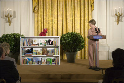 Mrs. Laura Bush talks with Elmo, a puppet on the children's television show Sesame Street, in the East Room of the White House, Saturday, September 30, 2006, during the seventh annual National Book Festival opening ceremony in Washington, D.C. The festival, held on the grounds of the National Mall, will include author readings, book signings, musical performances, and storytelling for children, adults and families. More than 80 noted authors and artists from around the country will participate. White House photo by Shealah Craighead