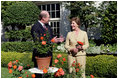 Mrs. Laura Bush smiles at Bill Williams, President and CEO of Harry & David Holdings, Monday, October 2, 2006, as she participates in a ceremony for the unveiling of the Laura Bush rose in The First Lady’s Garden at The White House. Founded in 1872, Jackson & Perkins is a leading hybridizer of garden roses and has launched The Laura Bush rose as part of the First Ladies Rose Series. The rose is a floribunda rose and has light yellow buds that open to a smoky coral color with yellow on the reverse petal. White House photo by Shealah Craighead 