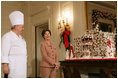 Mrs. Laura Bush and former chef Roland Mesnier discuss the gingerbread White House with the press in the State Dining Room Thursday, Nov. 30, 2006. The house consists of more than 300 pounds of dark chocolate and gingerbread. White House photo by Shealah Craighead 