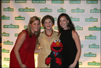 Mrs. Laura Bush is joined by her daughters Jenna Bush, left, and Barbara Bush, as they pose for a photo with Sesame Street character Elmo Wednesday evening, May 30, 2007, at the Sesame Workshop Fifth Annual Benefit Dinner in New York, where Mrs. Bush was honored for her commitment to literacy and education.