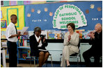 Mrs. Laura Bush joins Our Lady of Perpetual Help School principal Charlene Hursey, left, and Cardinal Theodore McCarrick, Archbishop of Washington, D.C., in applauding student Marquette Lewis, 11, after his reading of the poem “Coming of Age,” Monday, June 5, 2006. Mrs. Bush visited the school to announce a Laura Bush Foundation for America’s Libraries grant to Our Lady of Perpetual Help School. White House photo by Shealah Craighead 