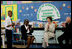 Mrs. Laura Bush joins Our Lady of Perpetual Help School principal Charlene Hursey, left, and Cardinal Theodore McCarrick, Archbishop of Washington, D.C., in applauding student Marquette Lewis, 11, after his reading of the poem “Coming of Age,” Monday, June 5, 2006. Mrs. Bush visited the school to announce a Laura Bush Foundation for America’s Libraries grant to Our Lady of Perpetual Help School.