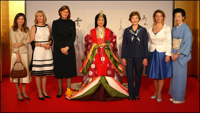 Spouses of G8 leaders pose with a model dressed in a Junihitoe, a 12-layered ancient kimono, following a demonstration of how this look is achieved, which was part of a traditional Japanese culture presentation on Monday, July 7, 2008, in Toyako, Japan. From left, the spouses are Mrs. Margarida Uva Barroso, wife of the President of the European Commission; Mrs. Laureen Harper, wife of the Prime Minister of Canada; Mrs. Sarah Brown, wife of the Prime Minister of the United Kingdom; Mrs. Laura Bush, Mrs. Svetlana Medvedeva, wife of the President of Russia; and Mrs. Kiyoko Fukuda, wife of the Prime Minister of Japan. The demonstration was presented at the Windsor Hotel Toya Resort and Spa's Bridal Salon in Toyako, Japan and the event celebrated the 1000th anniversary of the Tale of Genji, a Japanese classic written by Lady Murasaki. Junihitoe is an example of the formal court dress worn by women during Murasaki's time.