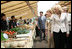 Mrs. Laura Bush joins spouses of the G8 leaders as they visit the Hokkaido Marche (northern farm market), in Makkari Village Tuesday, July 8, 2008. The Hokkaido Marche was especially organized by the local residents on the occasion of the Summit, with the aim of illustrating the richness of locally produced foods. In the foreground is Mrs. Laureen Harper, wife of the Prime Minister of Canada.