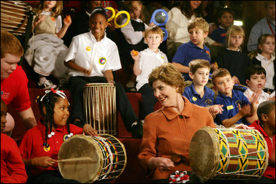 Mrs. Laura Bush joins in a musical number playing a drum with children at the Louisiana Children’s Museum in New Orleans, Tuesday, Jan. 9, 2007, during her visit to see the rebuilding progress in the Gulf Coast region. The museum, closed nearly a year following the 2005 hurricanes, is working to address the needs of young children and families seeking a safe and nurturing environment. White House photo by Shealah Craighead 