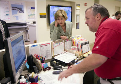 First Lady Laura Bush gets an update on the situation of efforts to help people in the aftermath of hurricane Katrina during a visit of Red Cross headquarters with President George W. Bush on Sunday September 4, 2005.
