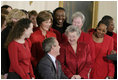President George W. Bush and Laura Bush joke with heart disease survivors after signing the American Heart Month Proclamation in the East Room Feb. 2, 2003.