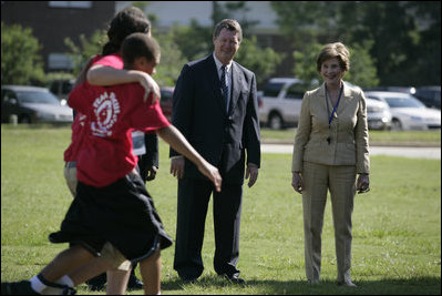 Mrs. Laura Bush and Mike Gottfried, CEO of Team Focus, watch Team Focus participants run a relay race Thursday, June 21, 2007, in Mobile, Ala., during a visit to Team Focus’ National Leadership Camp, as part of Helping America’s Youth initiative. Team Focus is a faith-based, nonprofit organization devoted to improving the lives of young men, ages 10-18, without fathers in their lives.