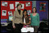 Mrs. Laura Bush embraces 10-year-old Taylor Rice, whose father is currently serving overseas in the Army Reserves, during a visit to the Learning Center at Andrews Air Force Base in Maryland, Wednesday, Dec. 5, 2007, where Mrs. Bush participated is a roundtable discussion on the special needs of military youth and families.