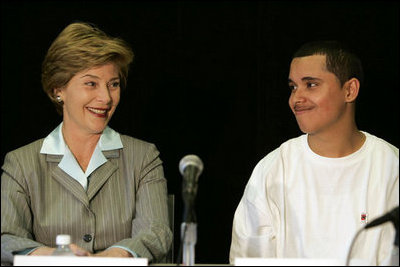 Laura Bush talks with Freddy Martinez, 17, during a roundtable discussion on stopping violent crime in Chicago on June 2, 2005. CeaseFire Chicago is a public health initiative that works with community partners to reduce violence.