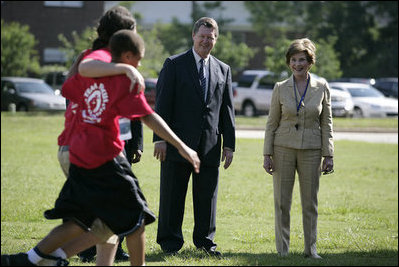  Mrs. Laura Bush and Mike Gottfried, CEO of Team Focus, watch Team Focus participants run a relay race Thursday, June 21, 2007, in Mobile, Ala., during a visit to Team Focus’ National Leadership Camp, as part of Helping America’s Youth initiative. Team Focus is a faith-based, nonprofit organization devoted to improving the lives of young men, ages 10-18, without fathers in their lives. 