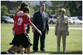  Mrs. Laura Bush and Mike Gottfried, CEO of Team Focus, watch Team Focus participants run a relay race Thursday, June 21, 2007, in Mobile, Ala., during a visit to Team Focus’ National Leadership Camp, as part of Helping America’s Youth initiative. Team Focus is a faith-based, nonprofit organization devoted to improving the lives of young men, ages 10-18, without fathers in their lives. 