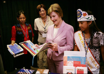Mrs. Laura Bush looks over reading materials on display Friday, Aug. 3, 2007, at the various information and educational booths of the Saint Paul Community Partnerships Serving American Indian Youth at the Helping America's Youth Fourth Regional Conference in St. Paul, Minn. White House photo by Chris Greenberg
