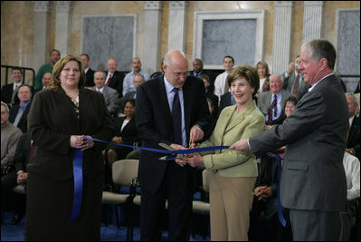 Mrs. Laura Bush is joined by U.S. Secretary of the Treasury Henry M. Paulson, Jr., left, and Richard C. Cote, curator, U.S. Department of the Treasury, as she cuts the ceremonial ribbon to mark the completion of the first major restoration at the U.S. Treasury Building, Thursday, Jan. 11, 2007, in Washington, D.C.