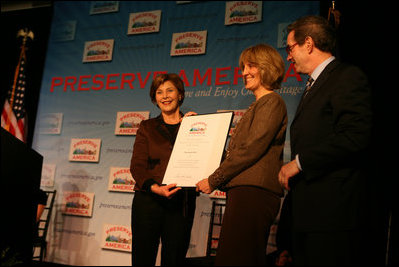 Mrs. Laura Bush presents fifth grade history teacher Maureen Festi, center, who teaches at Stafford Elementary School in Stafford, Conn., with the 2007 Preserve America National History Teacher of the Year Award at the Museum of the City of New York, Friday, Nov. 16, 2007 in New York. Dr. James Basker, president of the Gilder Lehrman Institute for American History looks on.