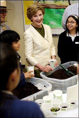 Mrs. Laura Bush joins students from the Williams Preparatory School in Dallas, Thursday, April 10, 2008, during a seed planting demonstration at the First Bloom program to help encourage youth to get involved with conserving America's National Parks. The First Bloom program is being introduced in five cities across the nation to give children a sense of pride in our natural resources and to be good stewarts of America's diverse environment.
