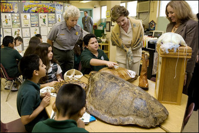 Laura Bush, listens to a student talk about Sea Turtles, Thursday, Feb. 16, 2006, as Fran Mainella, Director of the National Park Service, and Stella Summers, Teacher of the Gifted Science class, look on during a visit to Banyan Elementary School in Miami, FL, to support education about parks and the environment. White House photo by Shealah Craighead 