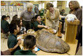 Laura Bush, listens to a student talk about Sea Turtles, Thursday, Feb. 16, 2006, as Fran Mainella, Director of the National Park Service, and Stella Summers, Teacher of the Gifted Science class, look on during a visit to Banyan Elementary School in Miami, FL, to support education about parks and the environment. White House photo by Shealah Craighead 
