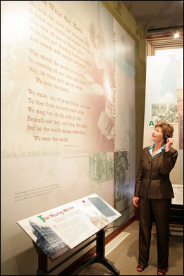 Mrs. Laura Bush listens to a reading of a Paul Laurence Dunbar poem during a tour of the Wright-Dunbar Village, a Preserve America neighborhood, in Dayton, Ohio, Wednesday, August 16, 2006. Paul Laurence Dunbar published a newspaper for the African American community, which the Wright Brothers printed for him in their printing shop. White House photo by Shealah Craighead 