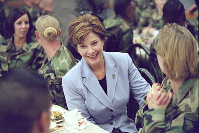 Laura Bush talks with members of the 101st Airborne at Fort Campbell, Kentucky. Known as "The Screaming Eagles," this airborne division took part in the largest airborne assault of World War II and also served in Vietnam. Surrounded by the soldiers, Mrs. Bush shares a turkey dinner with them Wednesday, Nov. 21, 2001. 