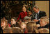 President George W. Bush and Mrs. Laura Bush share a moment with Malik Lawson during the Children's Holiday Performance Monday, Dec. 3, 2007, at the White House. The 7-year-old is the son of TSgt. Sherry Martin, currently serving in Iraq.