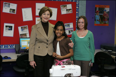 Mrs. Laura Bush embraces 10-year-old Taylor Rice, whose father is currently serving overseas in the Army Reserves, during a visit to the Learning Center at Andrews Air Force Base in Maryland, Wednesday, Dec. 5, 2007, where Mrs. Bush participated is a roundtable discussion on the special needs of military youth and families.