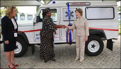 Mrs. Laura Bush and Mrs. Salma Kikwete, First Lady of Tanzania, exchange handshakes after Mrs. Bush presented Mrs. Kikwete with keys to an ambulance Sunday, Feb. 17, 2008, during her visit to Dar es Salaam. The ambulance will be donated to Sokoine Regional Hospital and will be used in the Lindi Region, one of the poorest and neediest in the country. The donation was a result of a joint visit to the hospital by Mrs. Kikwete and Pam White, left, USAID Mission Director.