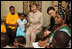 Mrs. Laura Bush joins a discussion with orphans and caretakers at the WAMA Foundation Sunday, Fab. 17, 2008 in Dar es Salaam, Tanzania, during a meeting to launch the National Plan of Action for Orphans and Vulnerable Children.