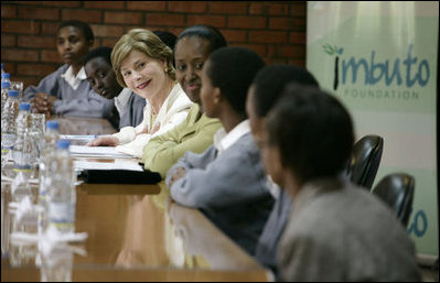 Mrs. Laura Bush joins Rwanda first lady Jeannette Kagame, center, as they listen to students during a forum Tuesday, Feb. 19, 2008 in Kigali, Rwanda, to promote girl's education.