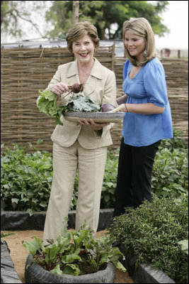 Mrs. Laura Bush and Ms. Jenna Bush pick vegetables during their visit to the Fann Hospital garden with Senegalese First Lady Viviane Wade and her daughter Tuesday, June 26, 2007, in Dakar, Senegal. Supported by USAID, the Fann Hospital gardens provide fresh vegetables to address the nutritional needs of patients with HIV/AIDS, an overlooked, but essential part of their care. 