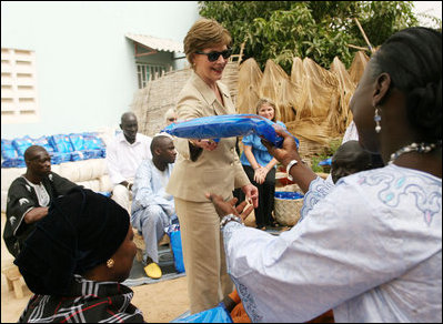 Mrs. Laura Bush hands out insecticide-treated malaria nets during a visit to Fann Hospital Tuesday, June 26, 2007, in Dakar, Senegal. Malaria is the single leading cause of death in Senegal. This year the United States is providing $16.7 million in assistance to combat the issue. The funding is part of the President’s Malaria Initiative that increases malaria funding by more than 1.2 billion dollars over five years.