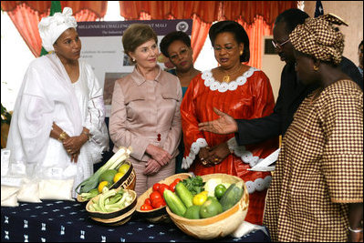 Mrs. Laura Bush listens to a briefing about the Millennium Challenge Corporation with First Lady Mrs. Toure Lobbo Traore and her daughter, Mrs. Bah Mabo Toure, Friday, June 29, 2007, in Bamako, Mali.