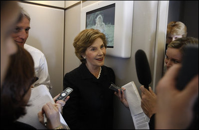 Mrs. Laura Bush speaks with members of the press June 13, 2008 aboard Air Force One, as she and President Bush travel from Rome to Paris on their multi-city European visit.