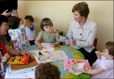 Mrs. Laura Bush helps a youngster blow bubbles at the Bethany House Orphanage Sunday, June 10, 2007, in Tirana, Albania. The orphanage is overseen by Bethany Christian Services of Michigan, and has been active in Albania since 1991.